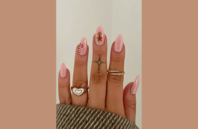Soft Pink almond nails with gingerbread nail man and candy accent