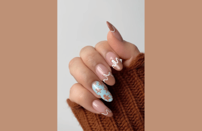Brown swrils nail idea with gingerbread and blue accents
