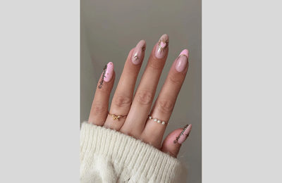 Light pink nails with gold chrome accents