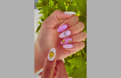 Gradient nails with yellow smiley faces and sunrise hues.
