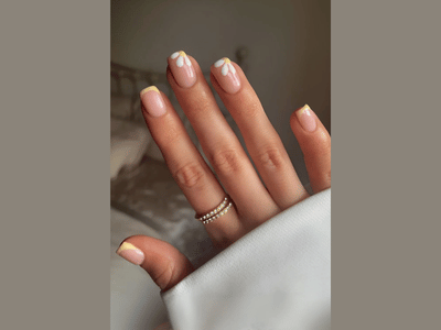 50 Stunning Short Spring Nail Designs Trending in 2025 12 Short spring nail art with yellow French tips, bright and sunny.
