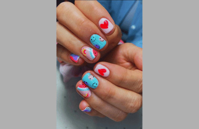 Pink and green nails with smiley faces capturing a fruity essence
