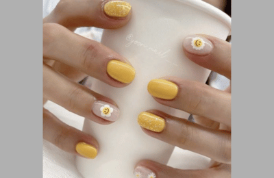 Coffee-toned nails with smiley faces for a cozy, warm feel