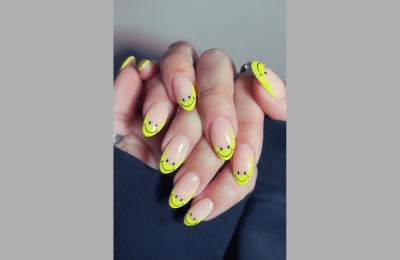 French tips with tiny smiley faces for a cheerful twist