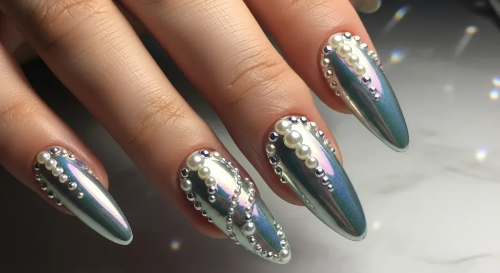 Close-up of nails featuring chrome and pearl accents with glossy metallic finishes and elegant pearlescent highlights.