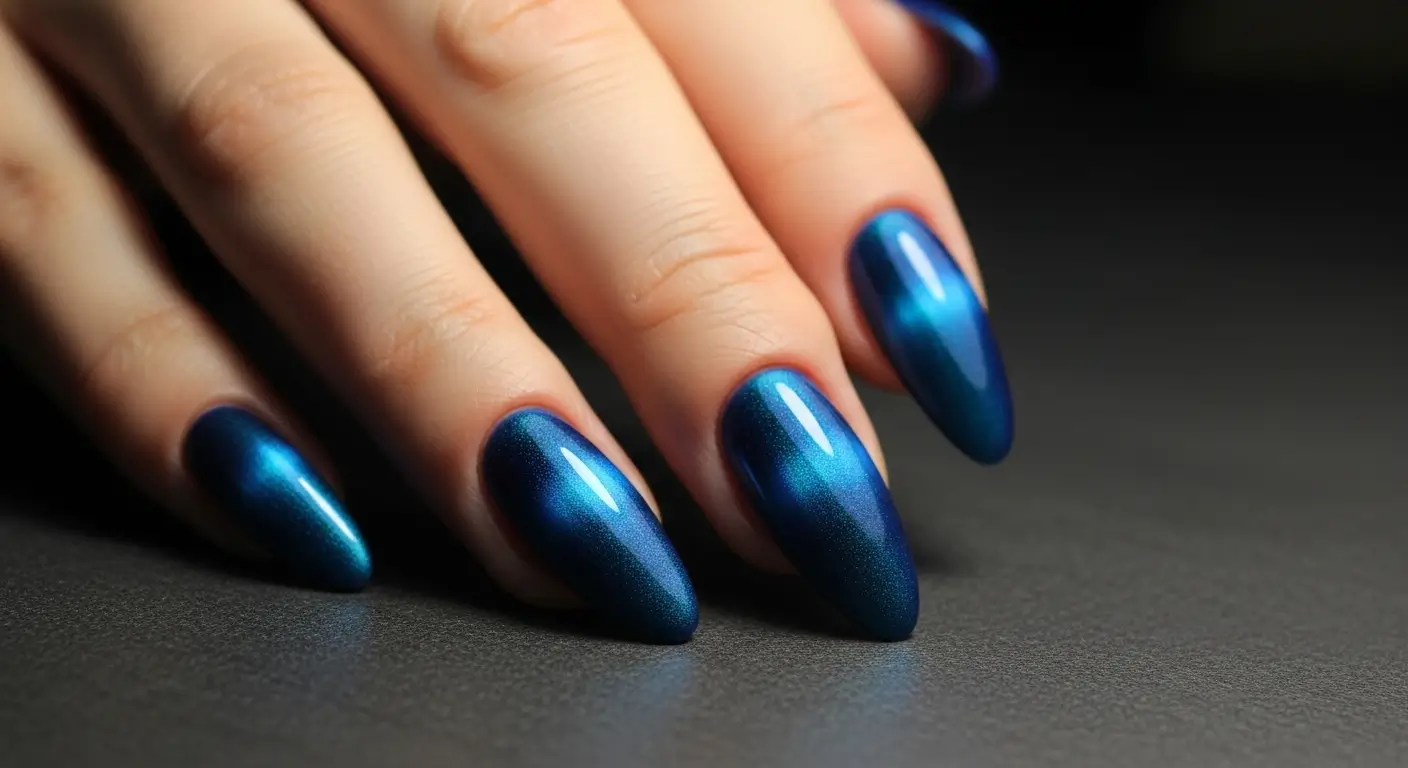 Bold blue cat eye nails with shifting light effects and matte finish option.