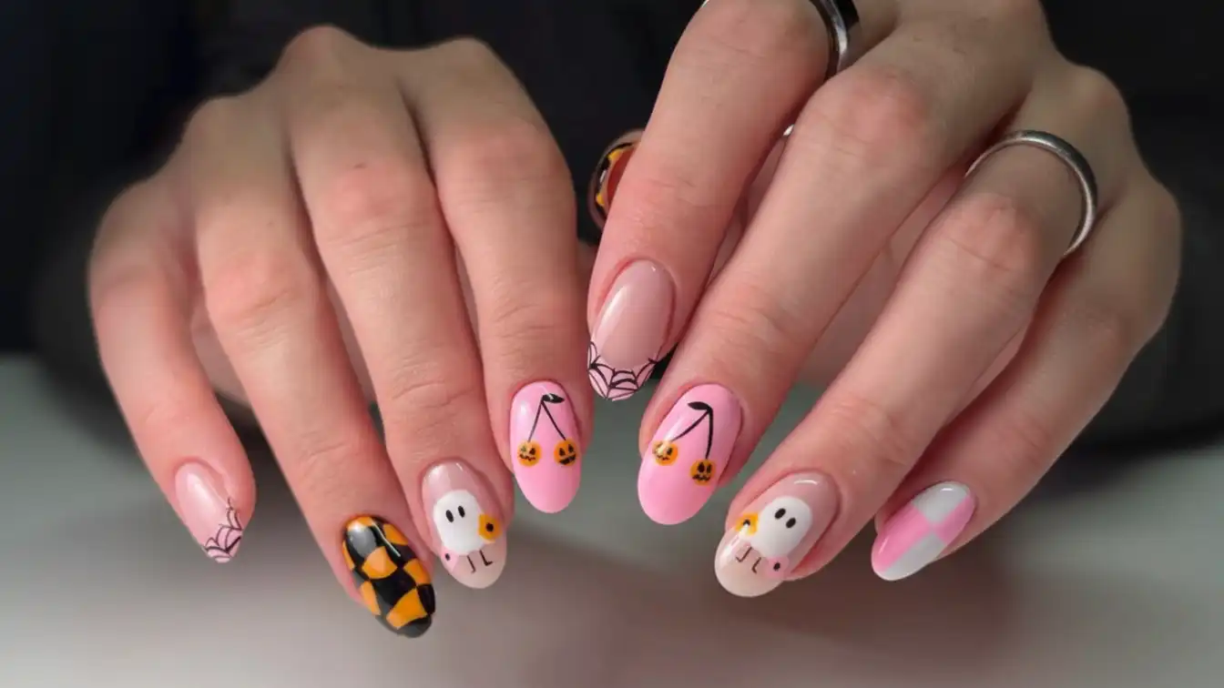 Pink nails with spider web French tips - girly Halloween spider nail designs.