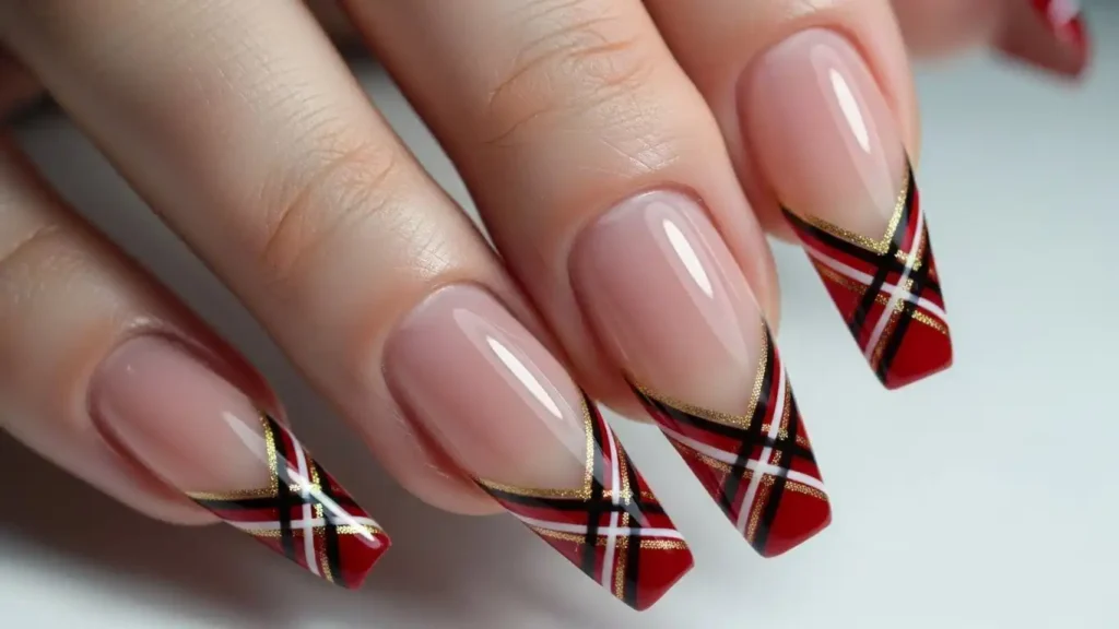 French tip plaid nail design featuring deep red tips over a nude base.